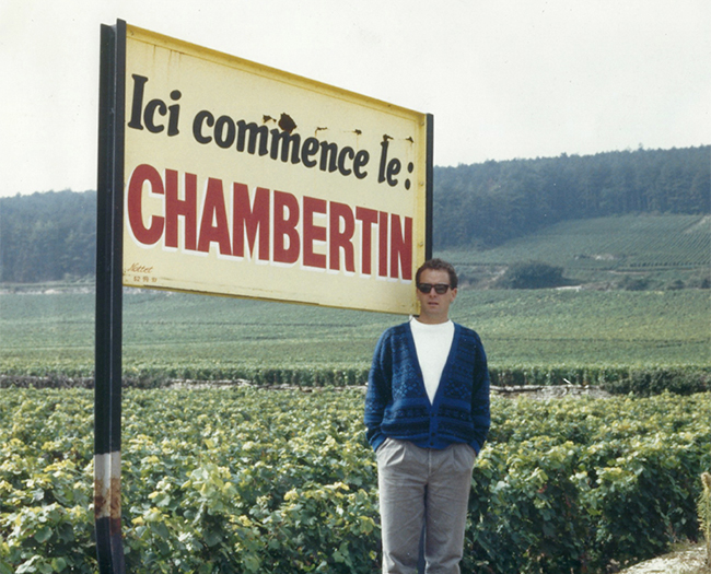 Jonathan Pey standing in front of a sign