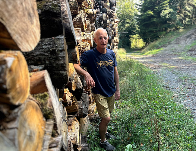 Jonathan Pey standing next to sustainably sourced French oak