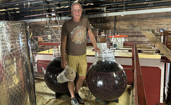 Jonathan Pey standing next to WineGlobes